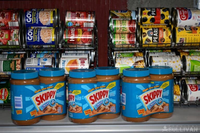 cans of peanut butter on pantry shelves