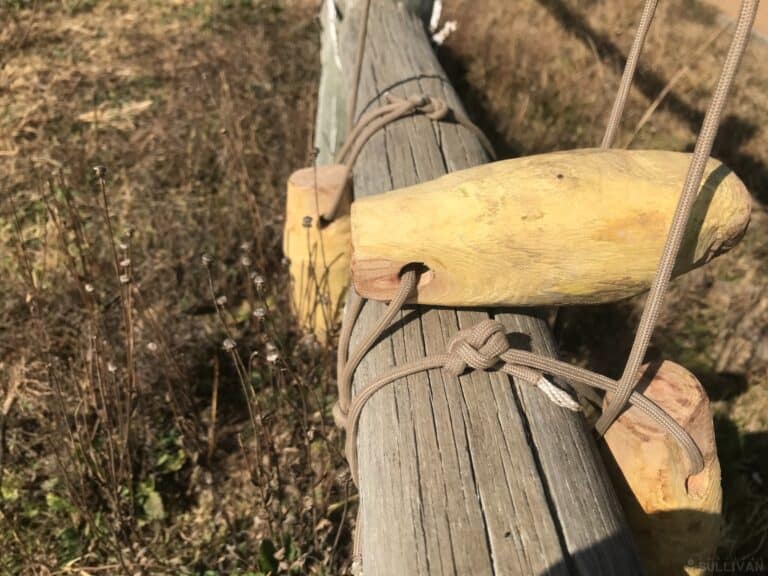 bola wrapped around wooden gate