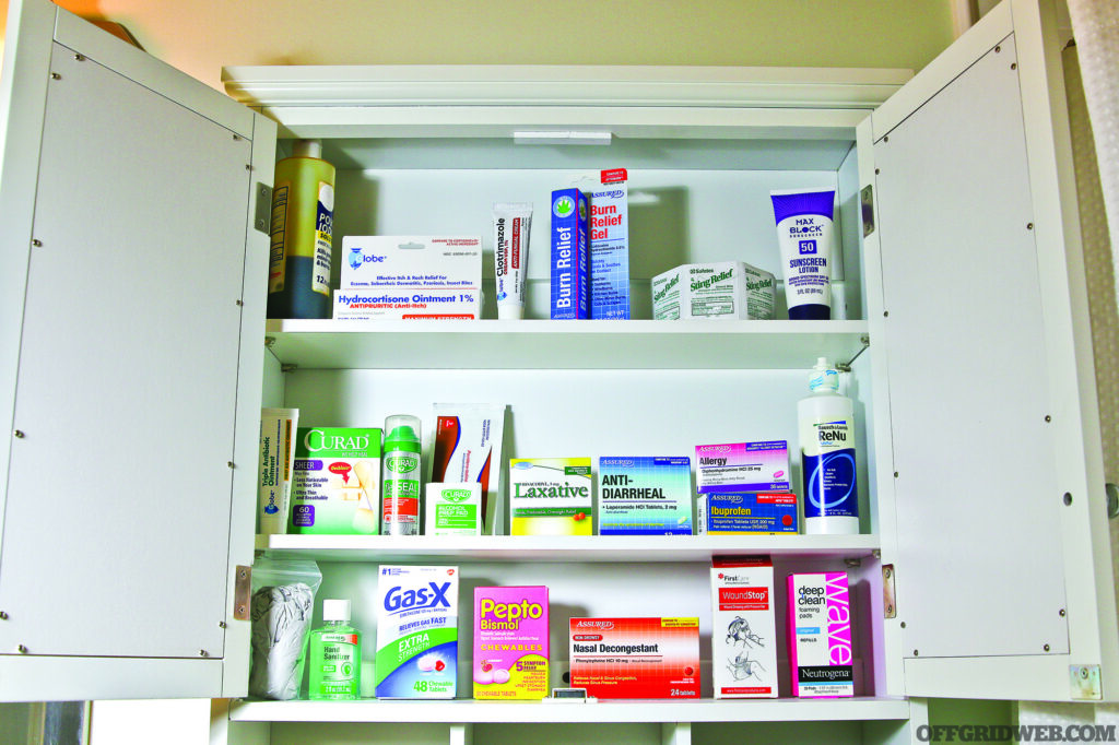 Front view of an open medicine cabinet filled with a variety of over the counter medicines.