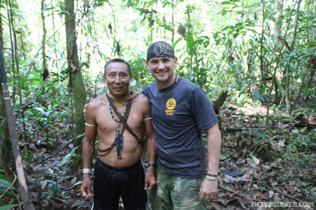 Outdoor photo of Joe Flowers standing with an Amazonian tribesman.