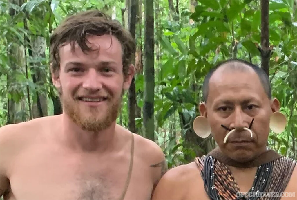 Photo of a shirtless Peter Magnin standing next to an Amazonian tribesman.