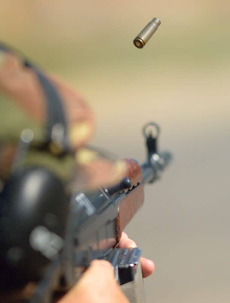 man shooting a riffle