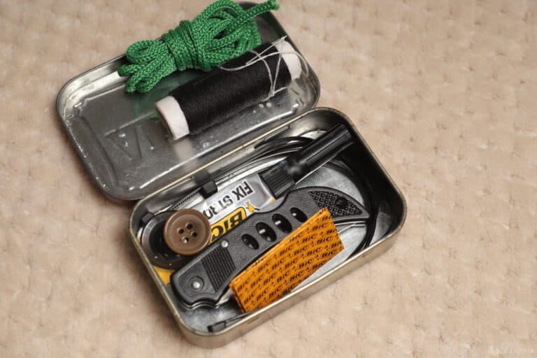 thread and needle paracord folding knife superglue and button inside Altoids tin