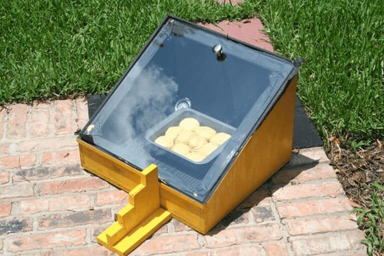 small DIY solar oven with tray of cookies baking inside