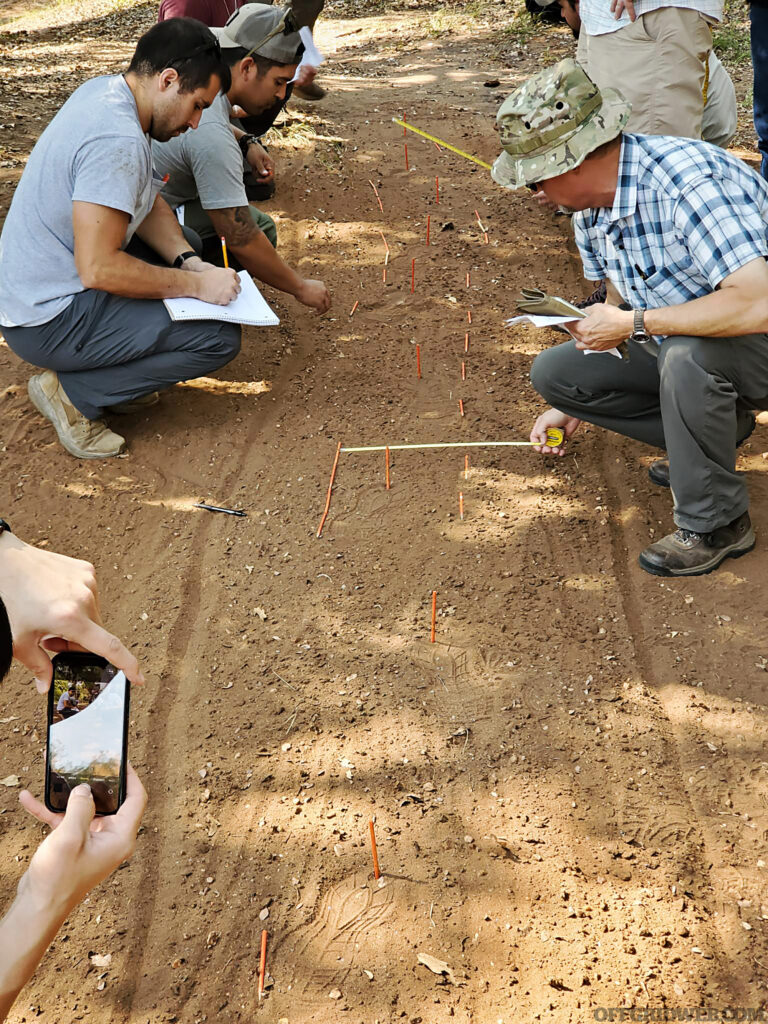 Photo of students analyzing footprints in a spoor pit during Craig Caudill's Tracking Fundamentals class.