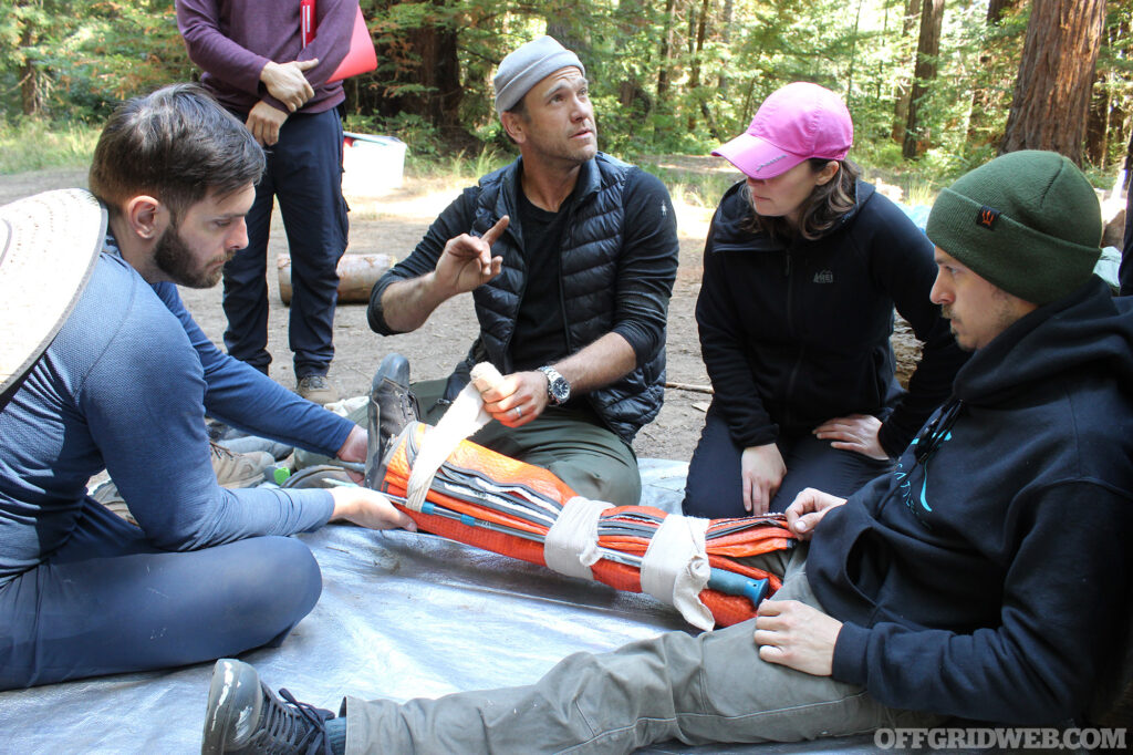 Students creating an improvised leg splint.