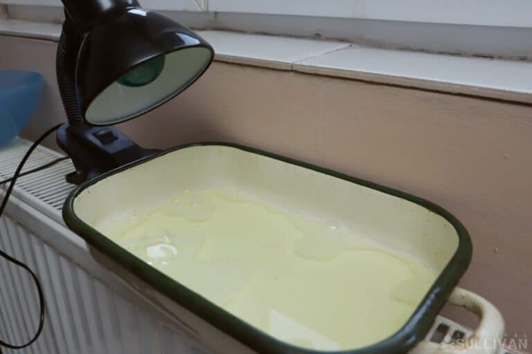 lamp next to metal tray filled with water and dish soap