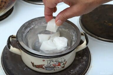 adding chopped wax to improvised double boiler