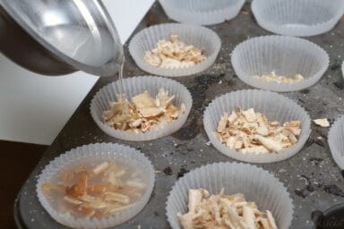 pouring wax into muffin cups