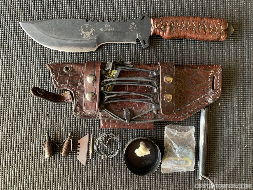 Photo of Naked and Afraid's Zach Benton's everyday carry items on display.