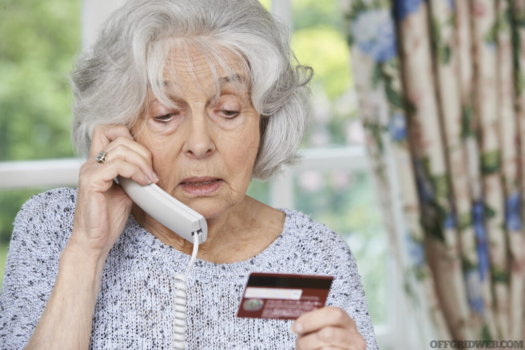 Senior Woman Giving Credit Card Details On The Phone