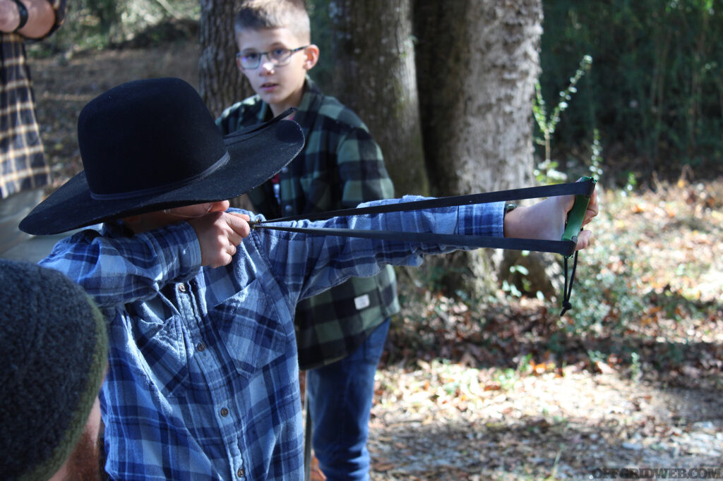 Student takes aim with a Simpleshot slingshot.