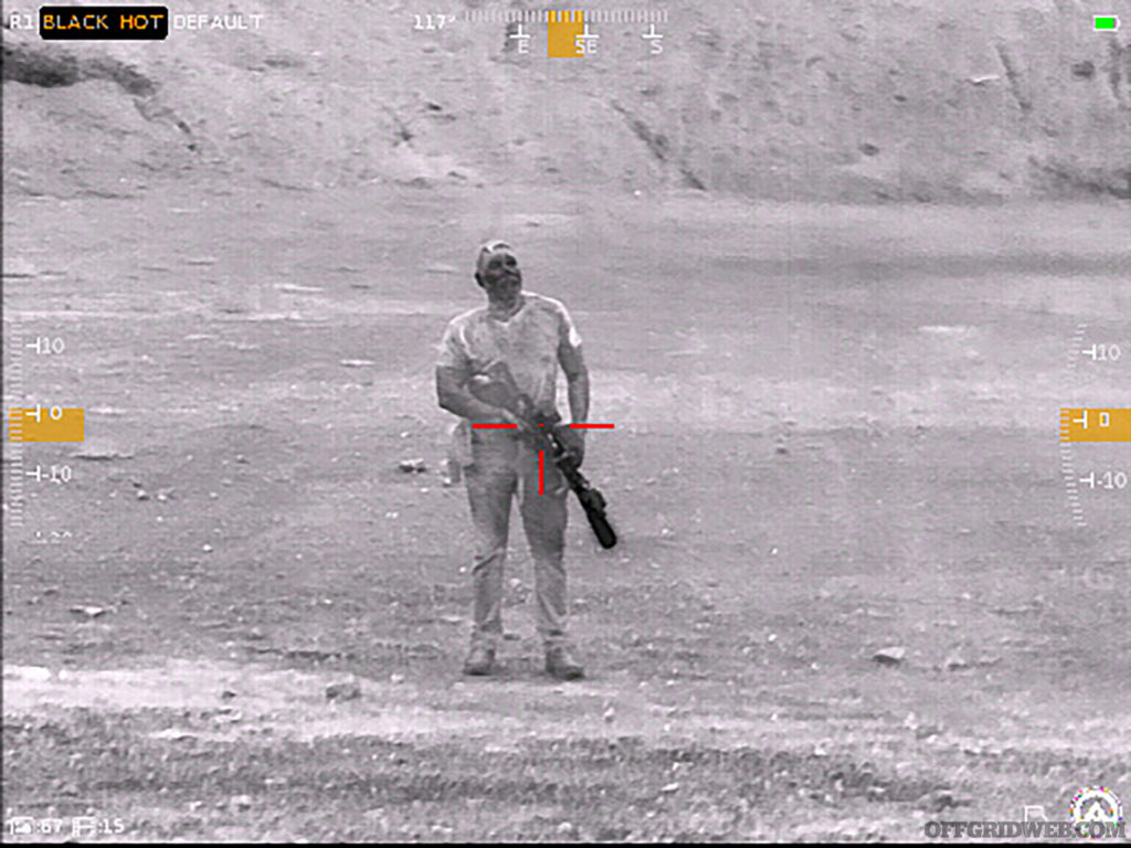 View of a man standing with a rifle through the Contractor 640.