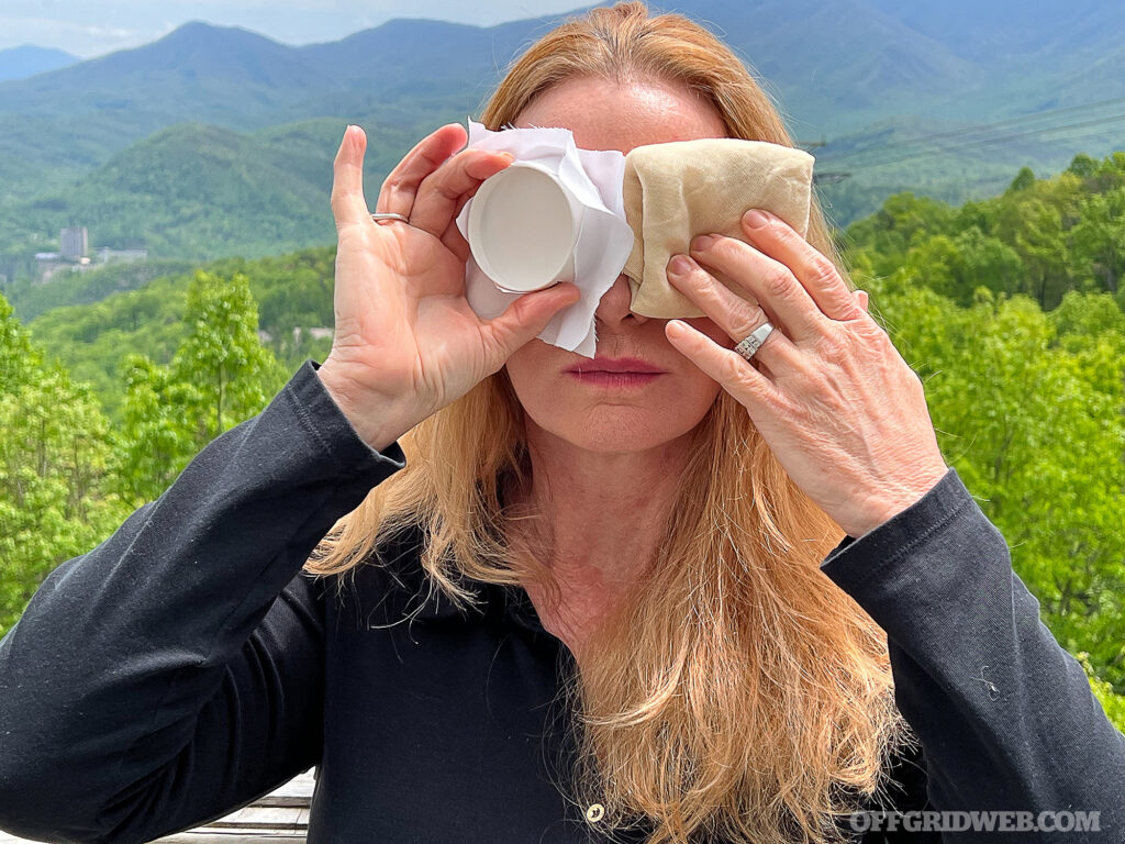 Covering the eyes with improvised bandages for the treatment of an eye injury.