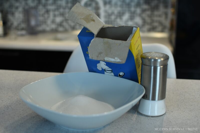 table salt in bowl in a box and in salt shaker