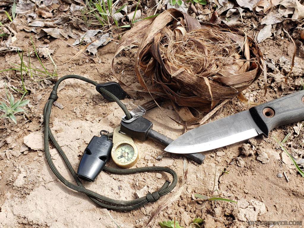 Photo of a ferro rod next to a knife.