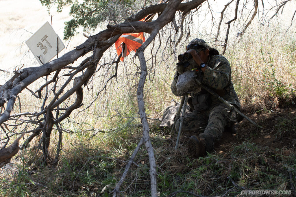 Gerald Hooee scans a mountain valley for signs of student movement.