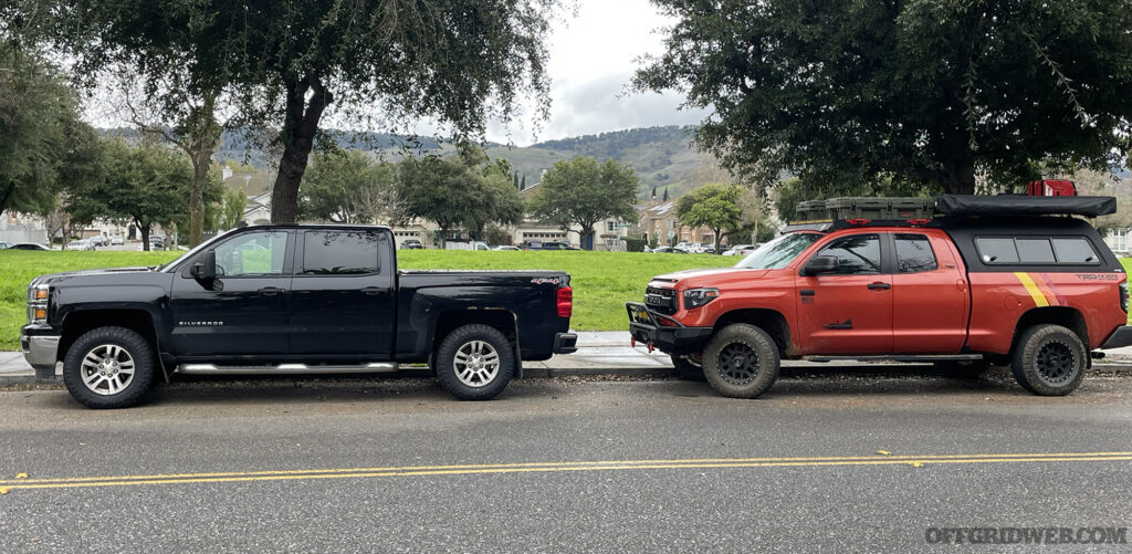 Two trucks parked side by side. One is obviously for overlanding. The other just looks like an average pickup truck.