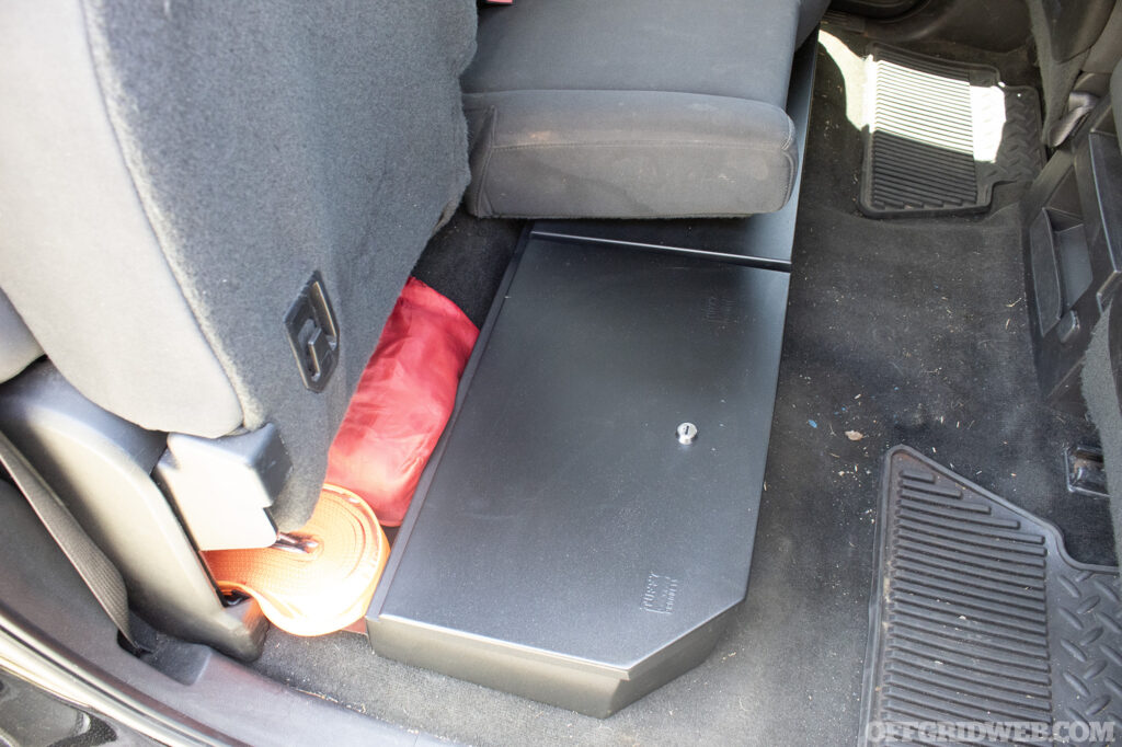 Photo of a closed Tuffy bench locker under the back seat of a pickup truck.