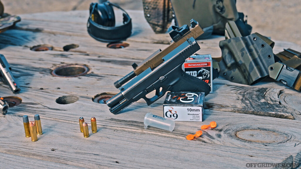 Photo of several 10mm handguns displayed on a table.