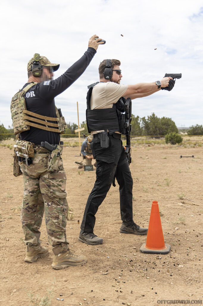 Two adult men training with a shot timer at BRVO Tactical's new training facility.