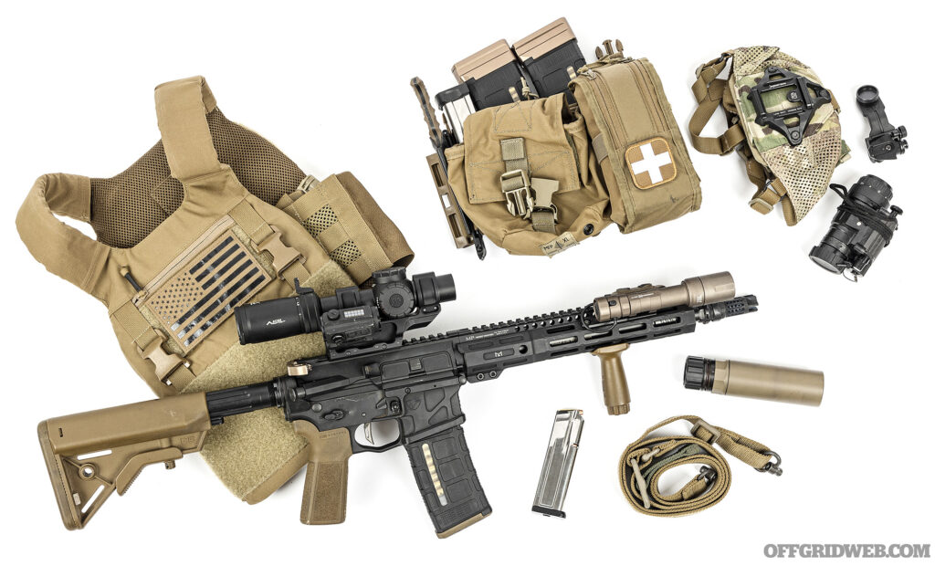 Studio photo of a plate carrier with a bunch of accessories, and a firearm.