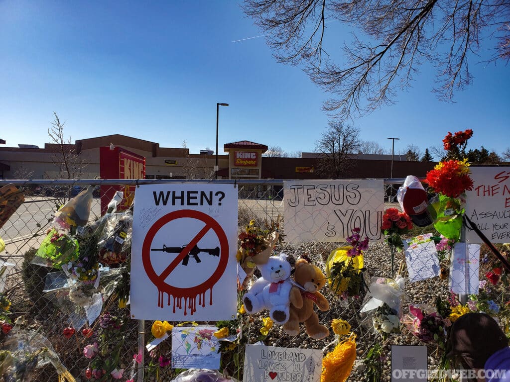 Boulder, Colorado, USA-March 29, 2021:Spontaneous memorial decorations and signs along fenced off site of March 22, 2021 King Soopers grocery store shooting in Boulder, Colorado killing 10.