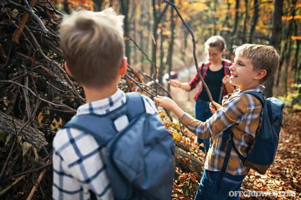 Image of a family with children in the woods looking at plants