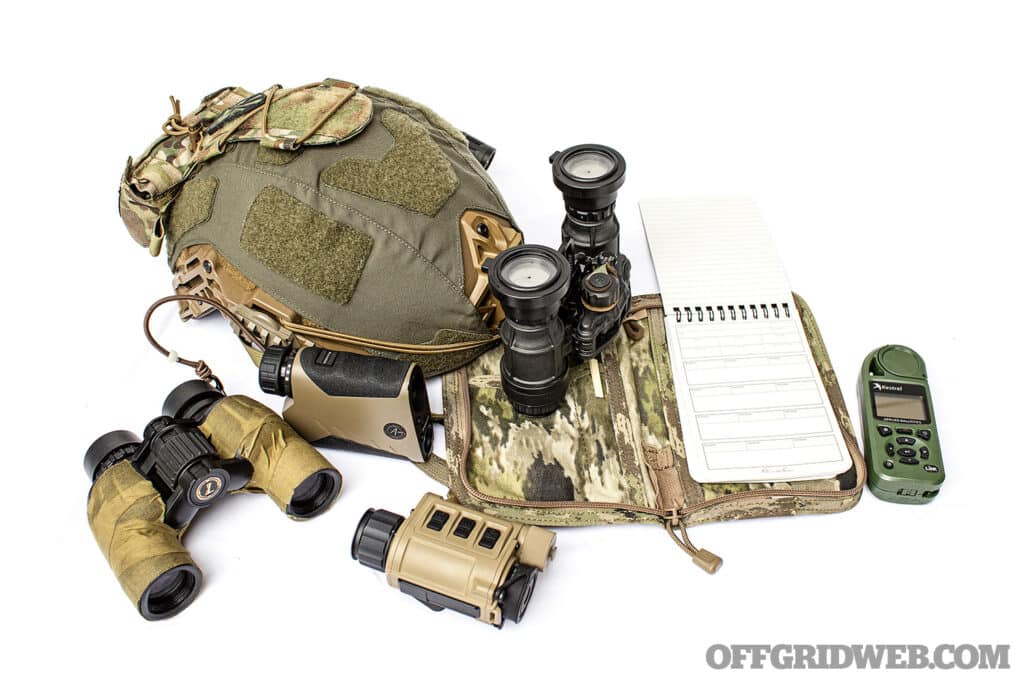 Image of assorted electronic view finders, military style helmet and a note pad