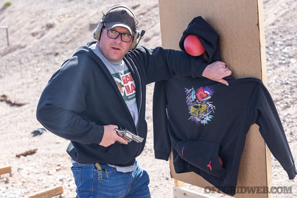 image of man with a wheelgun cup close to a target