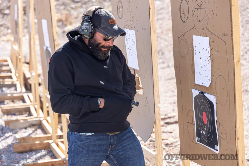 image of a man drawing wheel from concealed position close to a target