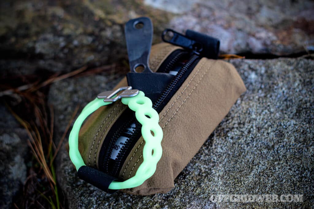 Image of a mini survival kit with a compact knife and survival supplies inside