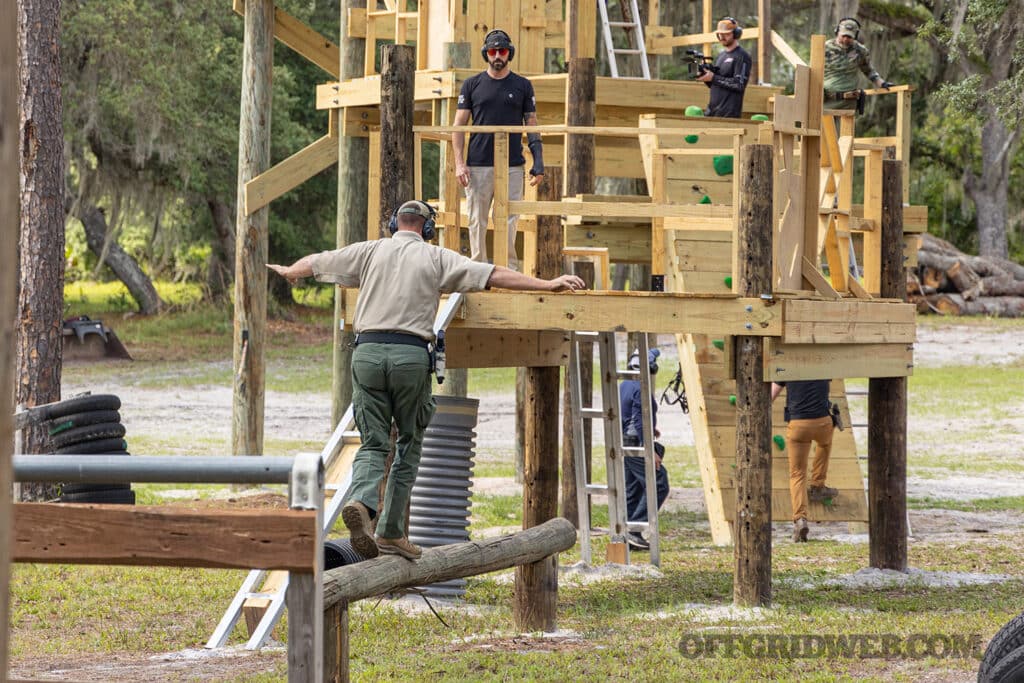 image of a man doing an obstacle course while equipped with a handgun and safariland holster during the Full Spectrum Warrior course