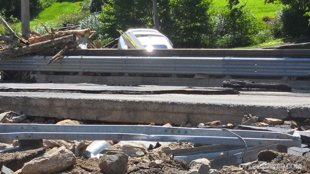 a destroyed bridge and car