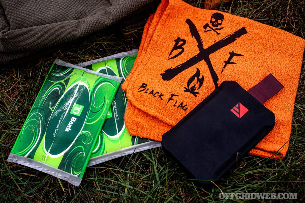 image of tissues, a battery pack and a shop rag with other bushcraft gear