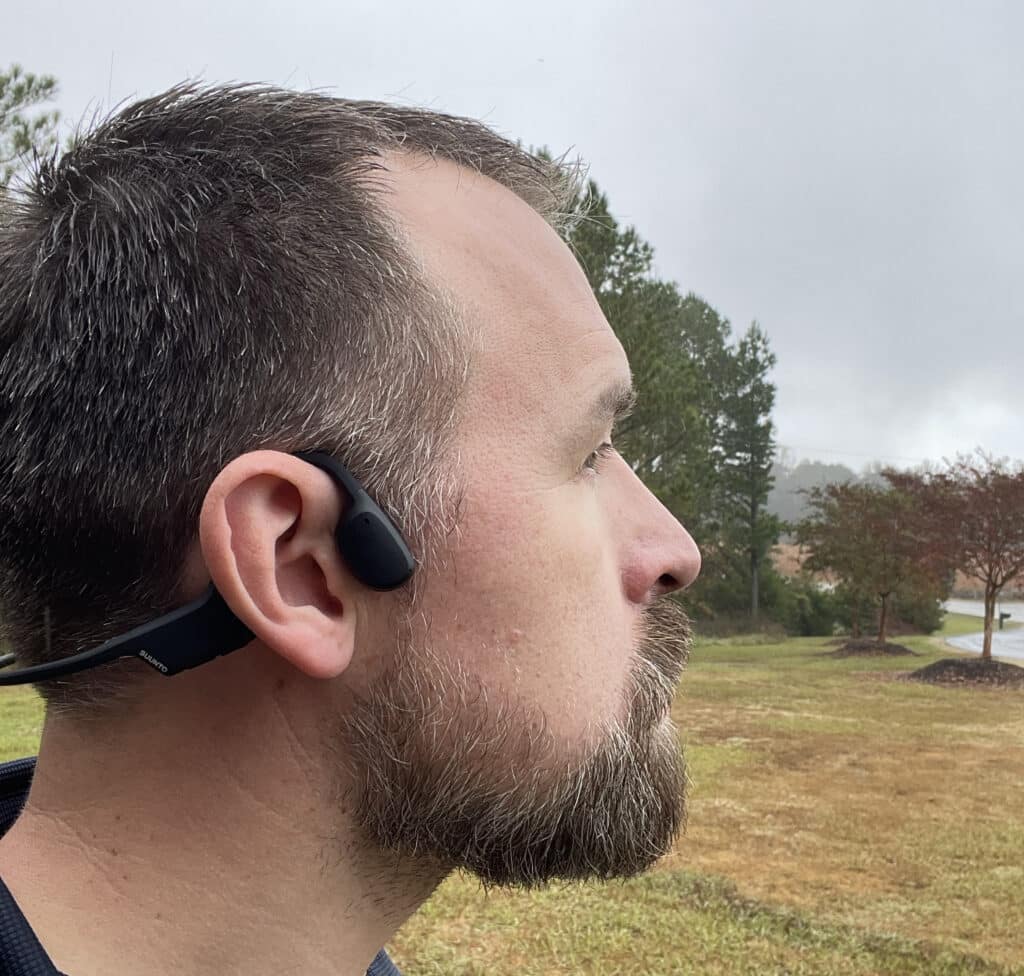 Adult male wearing suunto headphones.