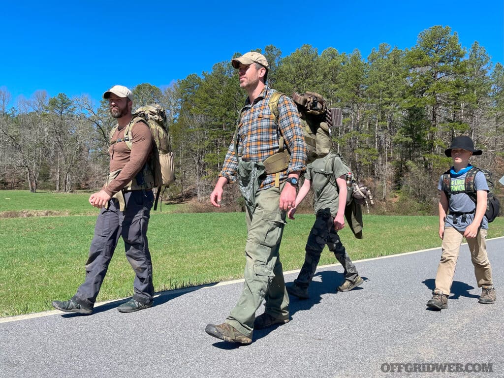 a family walking with bug out bags during a 911 down scenario