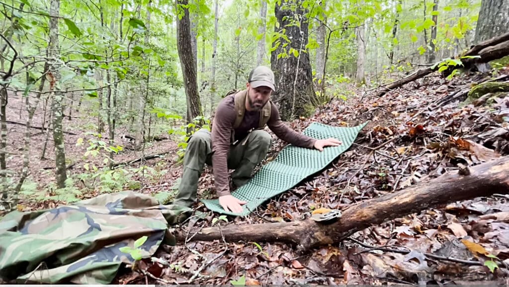 image of a man in the woods with survival gear