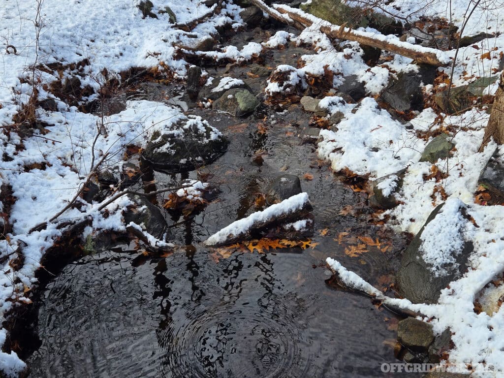 image of a stream in the winter with snow