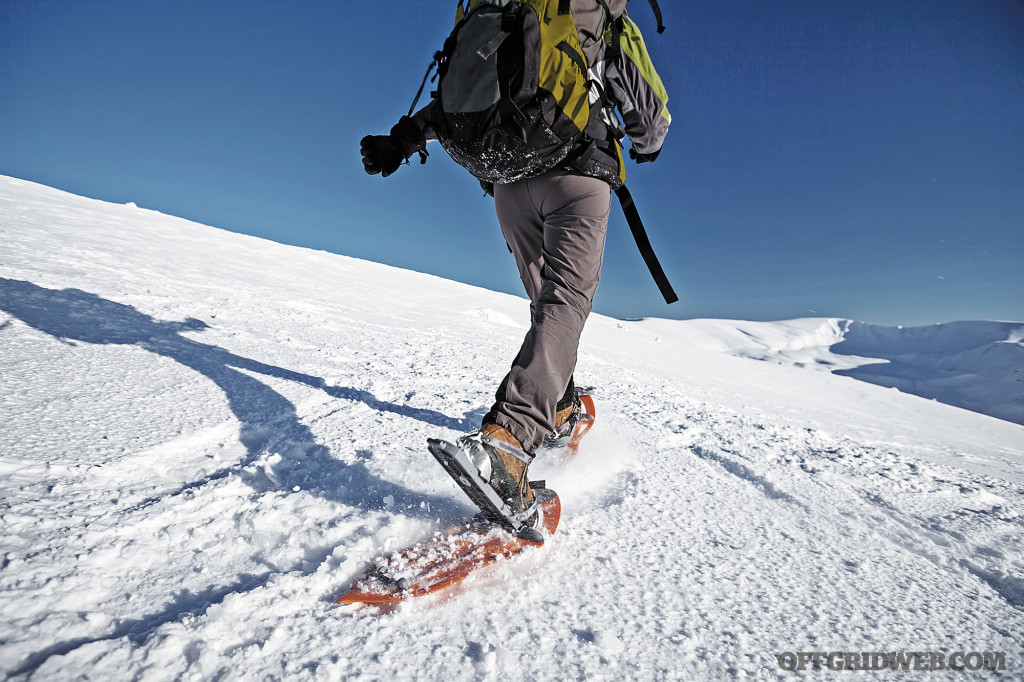 someone using snow shoes while winter hiking