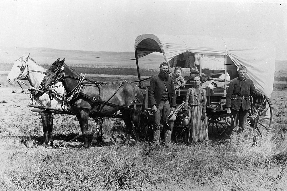 A pioneer family with their covered wagon, Nebraska, 1866.