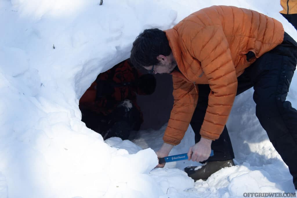 Jerry Saunders digging a snow shelter.