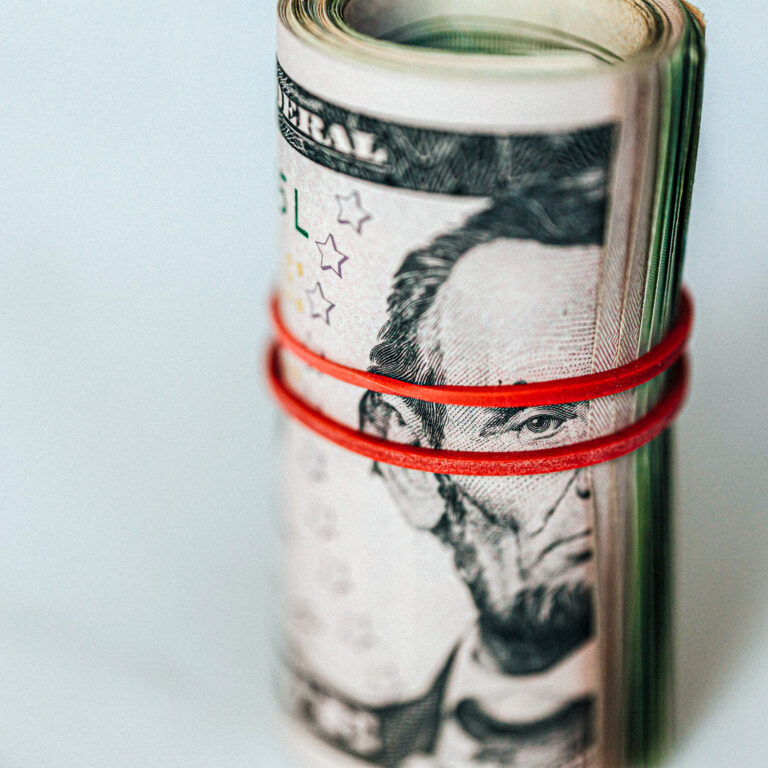 Roll of american dollars tightened with red band