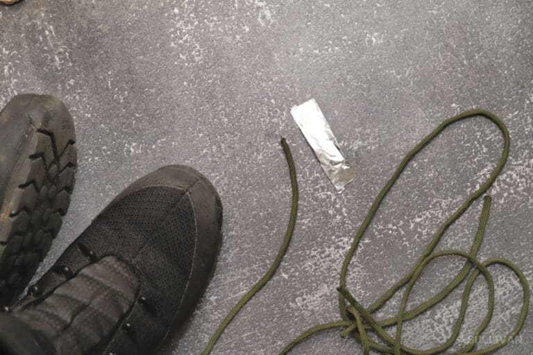 piece of aluminium foil next to boots and Paracord